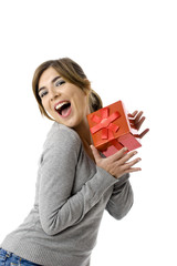 Portrait of an happy young woman holding a gift - isolated