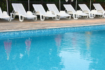 Swimming pool with comfortable chaise-longue
