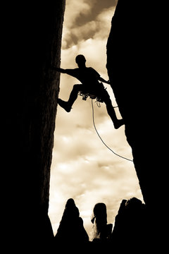 Climber clinging to a steep rock.