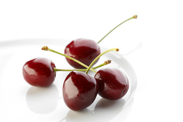 Fresh cherries in white bowl