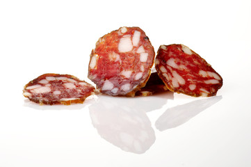 Slices of home made smoked salami isolated on white