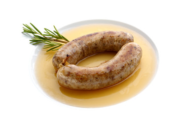 Grilled sausage in sauce with rosemary