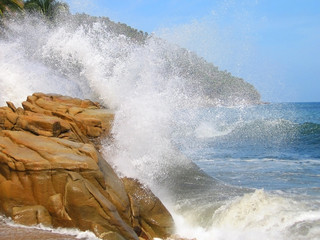 wave breaking on a rock