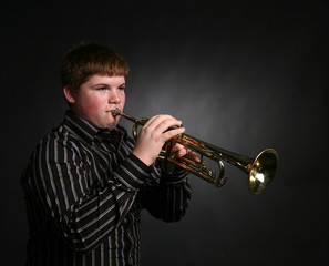 young boy playing trumpet © sparkmom