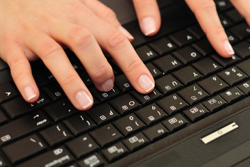 woman hands on laptop keyboard