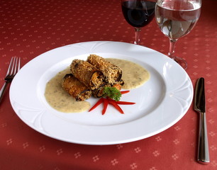 Dish of Italian cuisine -  meat pastry rolls with sauce