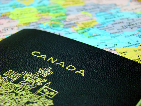 Photo of a Canadian passport against map of Europe.