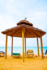 beach bungalo with beds in it's shade