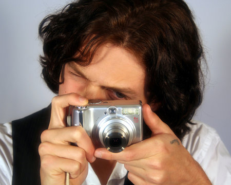 A Teen Takes a Picture with a Digital Camera