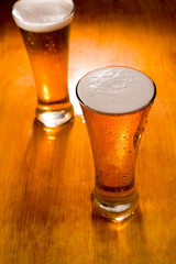 Two beer glasses, focus on first