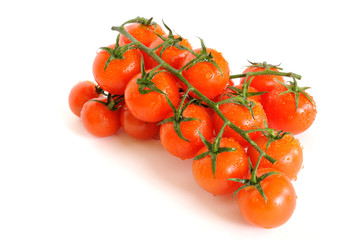 Bunch of cherry tomatoes with water drops isolated on white