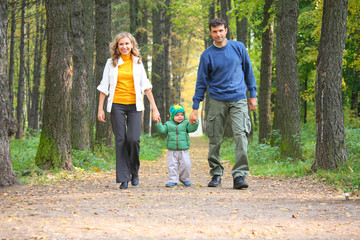 family in autumnal wood. focus on child