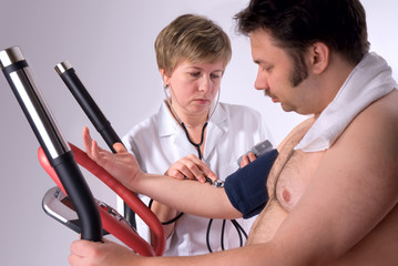 man is being observed by doctor after training