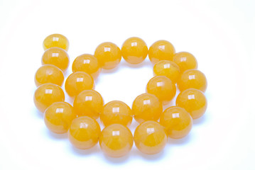 Orange beads, spiral, isolated