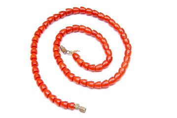 Red necklace on a white background, isolated, spiral