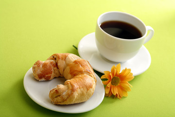 Breakfast concept with coffee and croissant