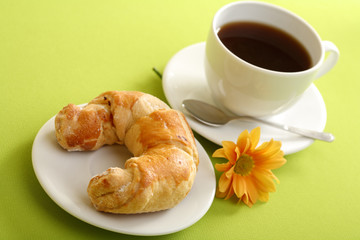 Breakfast concept with coffee and croissant