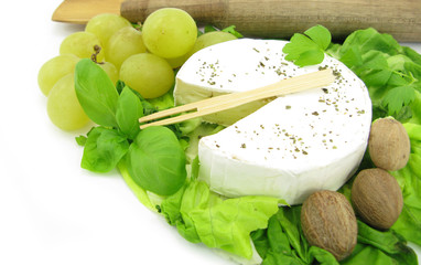 Camembert French cheese with grapes and basil