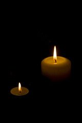 White candles on dark background