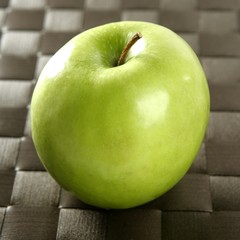 apple on a brown tablecloth