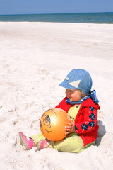 Child holds ball