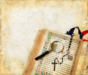 Bible, Rosary, and Magnifying Glass on a Grunge Background