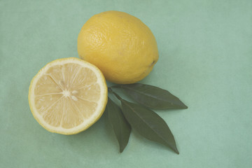 whole and half lemon with leaves