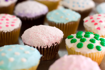 Assorted cupcakes with colorful frosting and various sprinkles