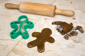 Rolling pin, cookie dough and cookie cutter on counter top