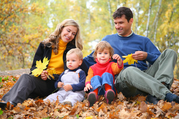 Fototapeta premium Parents look at children in autumn park