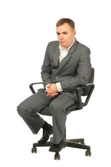 serious businessman sits on chair