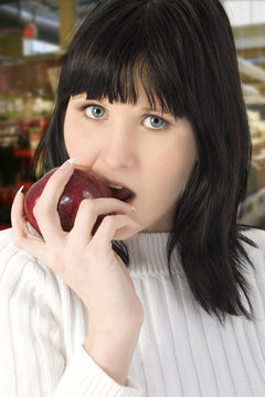 Beautiful Young Woman Eating Apple