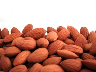 Macro photo of raw almonds isolated on white