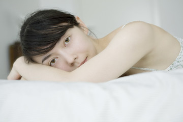 Woman lying in bedroom smiling