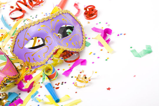 carnival masks and colorful confetti on white