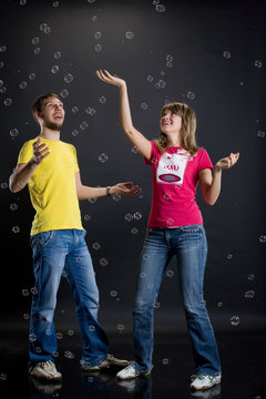 Young Couple Playing With Air Bubbles
