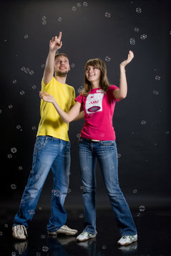 Young Couple Playing With Air Bubbles