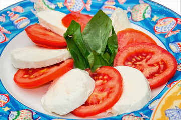 Caprese. Tomato and mozzarella salad with basil..