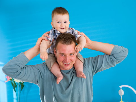 Father Lifting Happy Baby