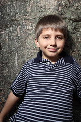 Boy leaning back on a tree
