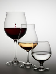 Glasses with red wine, white wine and water.