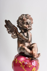 little angel sitting on ball