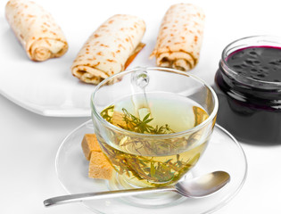 herbal tea with three pancake rolls and jam