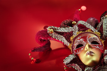 Ornate carnival mask over  textured metallic background