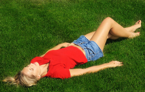 Beautiful Woman Is Sunbathing In The Park