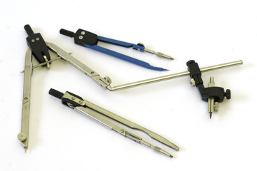 three compasses on white