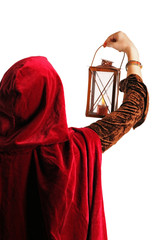 girl in red cloak with a candle-lantern, isolated on white
