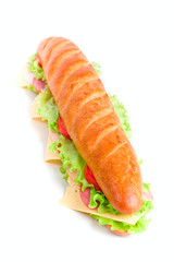 long sandwich with lettuce, tomatoes, ham, turkey and cheese