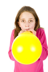 Fototapeta na wymiar Girl blowing balloon