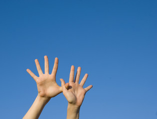 raised hands on blue sky background - 11251312